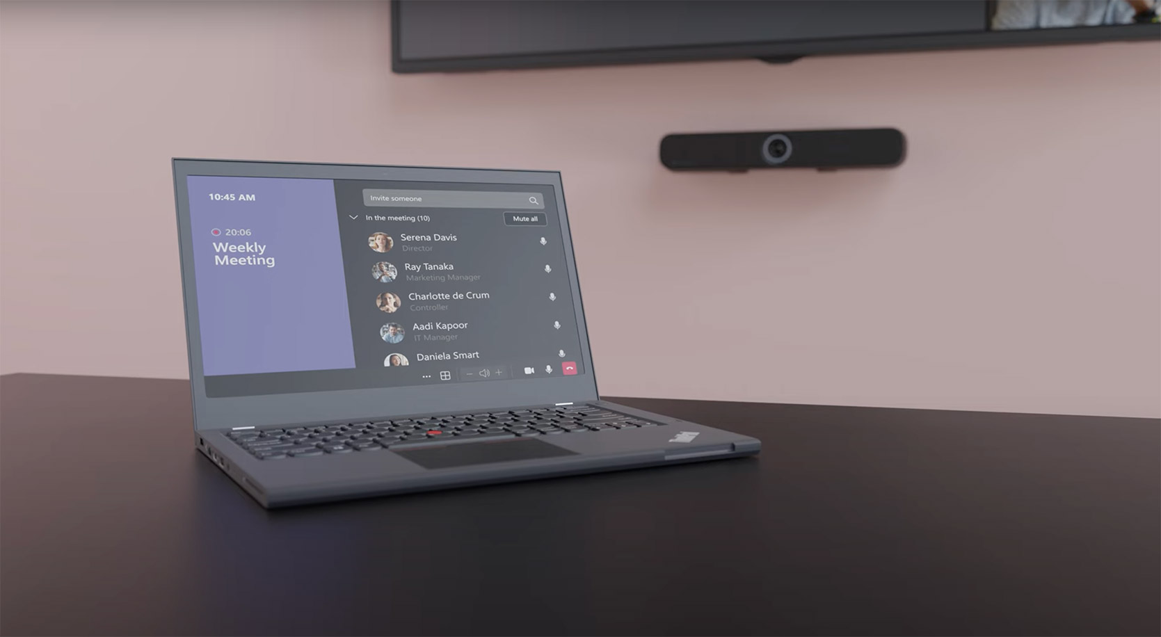 Laptop on table with the TeamConnect bar on the wall in the background.